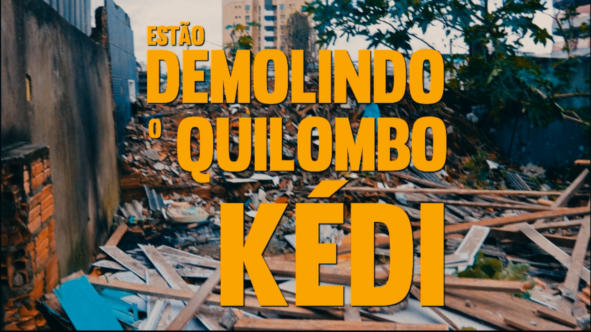 Fotografia mostra destroços de uma construção, tijolos e madeiras espalhados. Sobre a imagem o texto "Estão demolindo o Quilombo Kédi - Chamado para vigília"